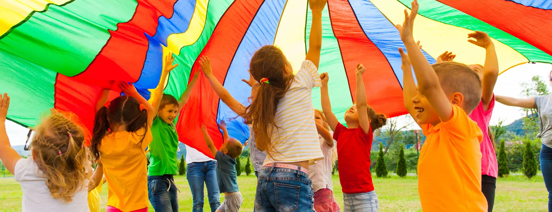 Amplify Marketing For Schools Blog - Private School Open House Ideas - children playing a game under a colourful canopy